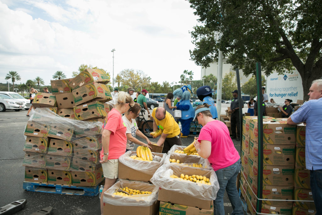 A group of volunteers distributing food donations